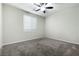Cozy bedroom featuring neutral carpet, a ceiling fan, and a window with blinds at 7629 Rosebark Cliffs St, North Las Vegas, NV 89084