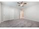 An airy bedroom with gray carpeting and a closet with sliding doors at 7629 Rosebark Cliffs St, North Las Vegas, NV 89084