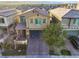 Two story home with landscaped front yard and brick paved driveway and attached garage at 7629 Rosebark Cliffs St, North Las Vegas, NV 89084