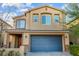 Charming two-story home featuring neutral stucco, a two-car garage, and manicured front yard at 7629 Rosebark Cliffs St, North Las Vegas, NV 89084