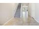 Bright foyer featuring tile floors, a carpeted staircase, and neutral paint throughout the space at 7629 Rosebark Cliffs St, North Las Vegas, NV 89084