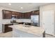 Modern kitchen features granite countertops, stainless steel appliances, and dark wood cabinets at 7629 Rosebark Cliffs St, North Las Vegas, NV 89084
