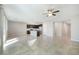 Open-concept living area featuring tile flooring, a ceiling fan, and access to the kitchen at 7629 Rosebark Cliffs St, North Las Vegas, NV 89084
