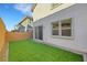 Private backyard with artificial grass, a brick wall, and sliding glass doors for easy indoor/outdoor living at 787 Cottonwood Hill Pl, Henderson, NV 89011