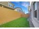 Low-maintenance backyard features a well-manicured lawn, a privacy wall, and direct access to the house at 787 Cottonwood Hill Pl, Henderson, NV 89011