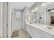 A luxurious bathroom with a double sink vanity, a large mirror and a glass shower at 787 Cottonwood Hill Pl, Henderson, NV 89011