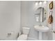 Clean powder room with a pedestal sink, toilet, and neutral wall color at 787 Cottonwood Hill Pl, Henderson, NV 89011