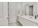 Bright bathroom featuring double sinks, white countertops, and modern fixtures at 787 Cottonwood Hill Pl, Henderson, NV 89011