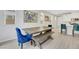 Bright dining area featuring a wooden table, bench seating, and stylish blue upholstered chairs at 787 Cottonwood Hill Pl, Henderson, NV 89011