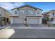 Contemporary home featuring a two-car garage, stone accents, and beautifully landscaped front yard at 787 Cottonwood Hill Pl, Henderson, NV 89011