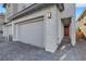 Modern home with a large two-car garage and stylish brick-paved driveway, offering convenience and curb appeal at 787 Cottonwood Hill Pl, Henderson, NV 89011