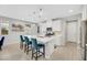 Modern kitchen with a large island, stainless steel appliances, white cabinets, and stylish pendant lighting at 787 Cottonwood Hill Pl, Henderson, NV 89011