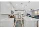 Bright kitchen with stainless steel appliances, white cabinetry, a large island, and an adjacent living area at 787 Cottonwood Hill Pl, Henderson, NV 89011