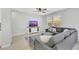 Comfortable living room with a gray sectional sofa, a decorative cabinet, and natural lighting at 787 Cottonwood Hill Pl, Henderson, NV 89011