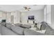 Cozy living room featuring a large gray sectional sofa, patterned pillows, and a ceiling fan at 787 Cottonwood Hill Pl, Henderson, NV 89011