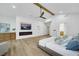 Spacious main bedroom featuring wood floors, a ceiling fan, and a modern electric fireplace at 8120 Pacific Cove Dr, Las Vegas, NV 89128