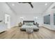 Bright main bedroom with wood floors, a ceiling fan, and modern furnishings at 8120 Pacific Cove Dr, Las Vegas, NV 89128