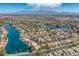 Aerial view of a Primary-planned community with lakes, lush landscaping, and mountain views at 8433 Sea Glen Dr, Las Vegas, NV 89128