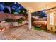 Backyard with an in-ground spa featuring a paver patio, palm trees, and string lights at 8433 Sea Glen Dr, Las Vegas, NV 89128