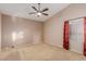 Spacious bedroom with vaulted ceiling, ceiling fan, carpet flooring, and large window at 8433 Sea Glen Dr, Las Vegas, NV 89128