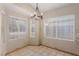 Cozy dining area with tile flooring, a modern chandelier, and large windows providing natural light at 8433 Sea Glen Dr, Las Vegas, NV 89128