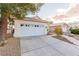 Charming single-story home featuring a two-car garage, neutral stucco exterior, and low-maintenance landscaping at 8433 Sea Glen Dr, Las Vegas, NV 89128
