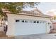 Spacious two-car garage with paneled door, concrete driveway, and manicured landscaping at 8433 Sea Glen Dr, Las Vegas, NV 89128