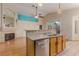 Open concept kitchen features granite countertops, stainless steel dishwasher, and breakfast bar at 8433 Sea Glen Dr, Las Vegas, NV 89128