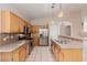 Well-equipped kitchen featuring stainless steel appliances, wood cabinetry, and granite countertops at 8433 Sea Glen Dr, Las Vegas, NV 89128