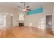 Spacious living room with hardwood floors, fireplace, ceiling fan, and a cohesive open floorplan at 8433 Sea Glen Dr, Las Vegas, NV 89128