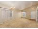 Bright living room with neutral carpet, chandelier lighting, and large windows for ample natural light at 8433 Sea Glen Dr, Las Vegas, NV 89128