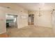 Open living room featuring neutral walls, carpet, and a chandelier, transitioning into other living spaces at 8433 Sea Glen Dr, Las Vegas, NV 89128