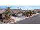 Aerial shot of a home featuring desert landscaping, a two-car garage, and mature palm trees at 870 Santa Maria Way, Mesquite, NV 89027