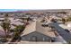 This aerial shot features a sprawling single-story home with desert landscaping, a spacious yard, and neighborhood street access at 870 Santa Maria Way, Mesquite, NV 89027