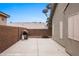 Wide backyard view with a concrete patio, grill, privacy wall, and mountain views at 870 Santa Maria Way, Mesquite, NV 89027