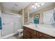 This bathroom has a shower, a wood cabinet and a white sink at 870 Santa Maria Way, Mesquite, NV 89027