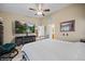 Bright primary bedroom featuring a large television, a ceiling fan, and neutral paint colors at 870 Santa Maria Way, Mesquite, NV 89027