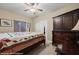 Bedroom featuring a large bed, wooden furniture, and natural light from the window at 870 Santa Maria Way, Mesquite, NV 89027