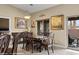 Elegant dining room with a classic wooden table set and sliding glass doors leading to the outdoor area at 870 Santa Maria Way, Mesquite, NV 89027