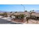 Charming single-story home featuring a well-manicured yard and a two-car garage, complemented by a backdrop of scenic mountains at 870 Santa Maria Way, Mesquite, NV 89027