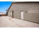 Exterior view of the side of the home featuring an entry door and gated parking at 870 Santa Maria Way, Mesquite, NV 89027