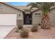 Charming home featuring desert landscaping, decorative security gate, and attached garage at 870 Santa Maria Way, Mesquite, NV 89027