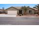 Welcoming home featuring a two-car garage, manicured landscaping, and a charming entrance at 870 Santa Maria Way, Mesquite, NV 89027