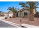 Attractive single-story home with desert landscaping, garage, and unique pineapple palm trees at 870 Santa Maria Way, Mesquite, NV 89027