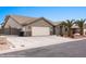 Well-maintained home with a spacious driveway, desert landscaping, and a two-car garage at 870 Santa Maria Way, Mesquite, NV 89027