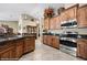 Kitchen with stainless steel appliances, granite countertops, natural wood cabinets and tile flooring at 870 Santa Maria Way, Mesquite, NV 89027