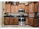 Functional kitchen with stainless steel appliances, granite countertops, and wood cabinetry at 870 Santa Maria Way, Mesquite, NV 89027