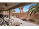 A covered patio with lounge chairs and desert landscaping offers a relaxing outdoor space at 870 Santa Maria Way, Mesquite, NV 89027