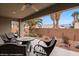 View of the patio with plenty of seating and a view of tropical palms and plants at 870 Santa Maria Way, Mesquite, NV 89027