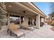 Covered patio with lounge chairs and comfortable seating for outdoor relaxation and entertaining at 870 Santa Maria Way, Mesquite, NV 89027